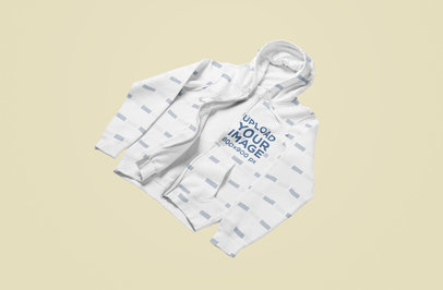 Mockup of a Sublimated Full-Zip Hoodie Tossed on a Solid Surface