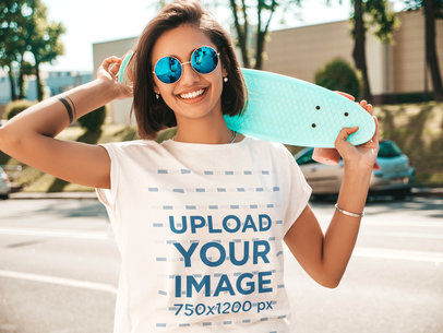 T-Shirt Mockup Featuring a Happy Woman With Sunglasses Holding a Small Skateboard 