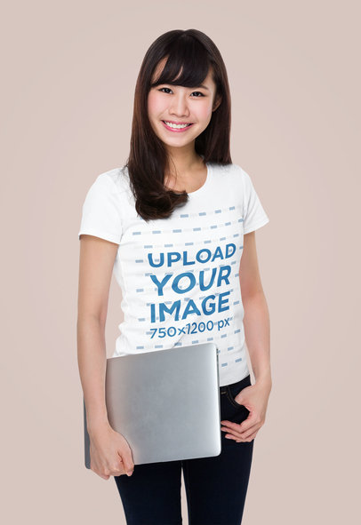 T-Shirt Mockup Featuring a Woman Holding a Laptop