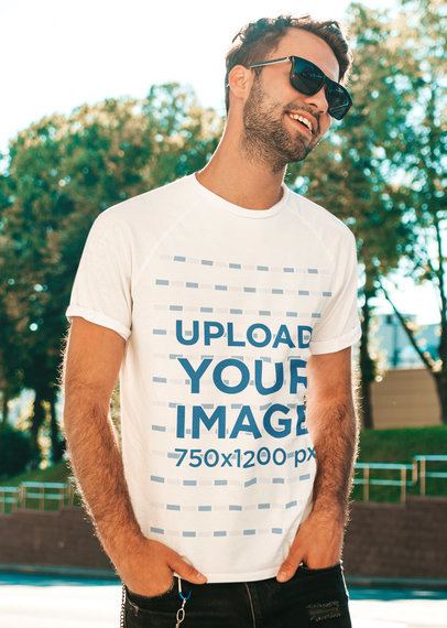 T-Shirt Mockup Featuring a Man With Sunglasses Posing at a Park 