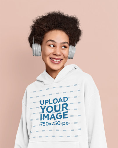 Hoodie Mockup of a Happy Woman Listening to Music in a Studio
