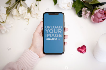 Mockup of a Woman Holding an iPhone 11 by Valentine's Day Roses 5143-el1