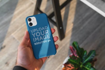 Mockup of a Man's Hand Holding a Phone With a Customizable Case 