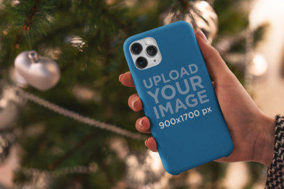 Phone Case Mockup Featuring a Christmas Tree in the Background 