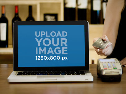 Mockup of a MacBook Pro on a Wine Store's Counter