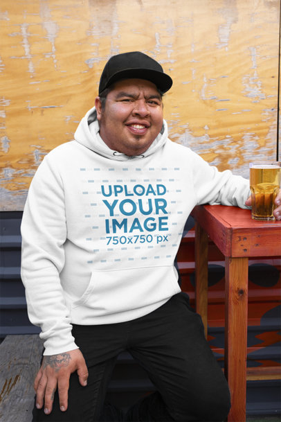 Hoodie Mockup Featuring a Happy Man Having a Beer 