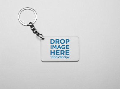 Small Keychain Mockup Lying on a Solid Color Surface