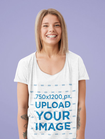 Mockup of a Tattooed Woman Wearing a Deep V-Neck T-Shirt in a Studio