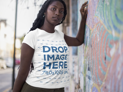Woman Lying Against a Colorful Wall Wearing a Round Neck Tee Mockup a15558