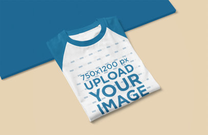 Mockup of a Folded Raglan T-Shirt Placed on a Surface