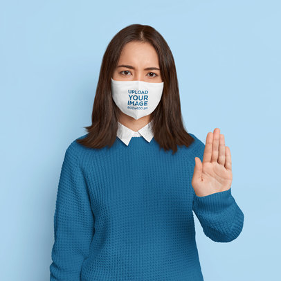 Face Mask Mockup of a Woman Doing a Stop Sign in a Studio