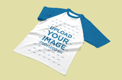 Mockup of a Raglan T-Shirt Laid Flat on a Customizable Surface