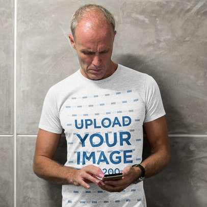 T-Shirt Mockup of a Senior Man Using His Smartphone m3303-r-el2