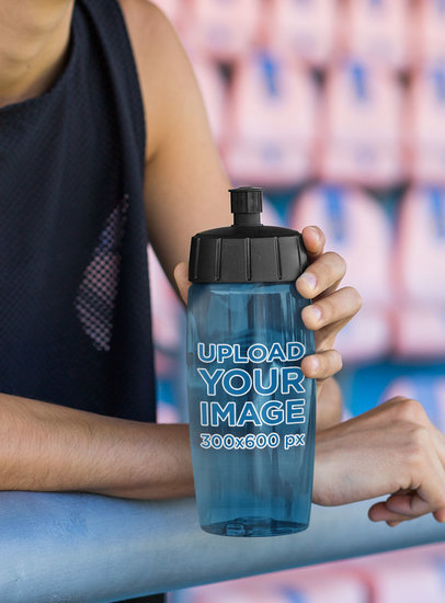 Mockup of a Female Athlete Holding a Bike Bottle