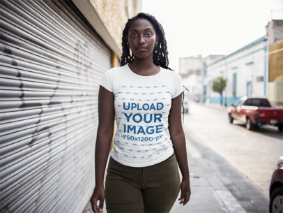 Mockup of a Woman Facing the Camera Wearing a Round Neck Tee While Outdoors