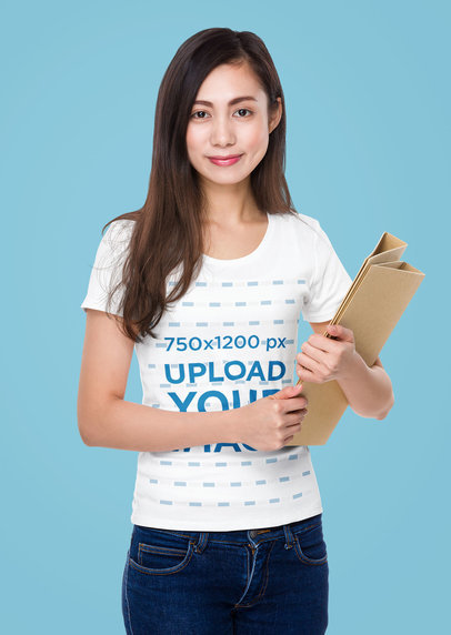T-Shirt Mockup of a Woman Holding Two Binders in Her Arms
