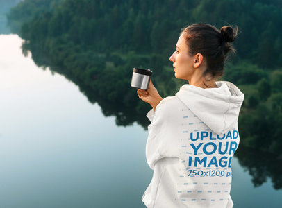 Back View Mockup of a Woman Wearing a Hoodie by a Lake 