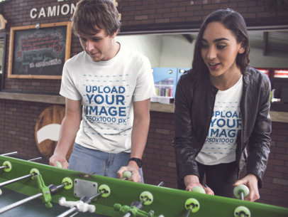 Young Couple Playing Foosball and Wearing Different Round Neck Tees Mockup