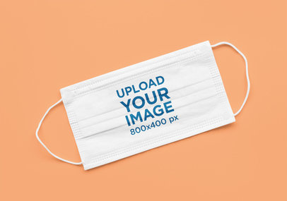 Mockup of a Flat Laid Face Mask over a Solid Surface