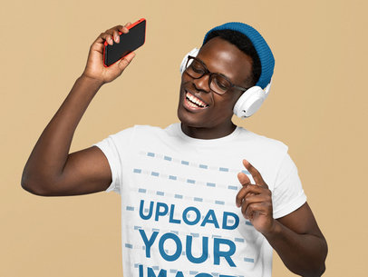 Basic T-Shirt Mockup of a Happy Man Listening to Fun Music at a Studio