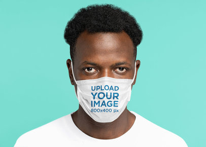 Face Mask Mockup of a Man With a Short Afro in a Studio