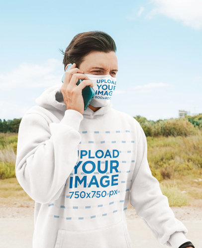 Hoodie and Face Mask Mockup Featuring a Man on the Phone
