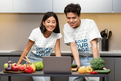 T-Shirt Mockup of a Couple Watching Cooking Tutorials