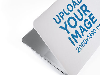 Template of a Laptop Cover from Behind and Above While Lying on a Closing Computer on a Solid Color Backdrop