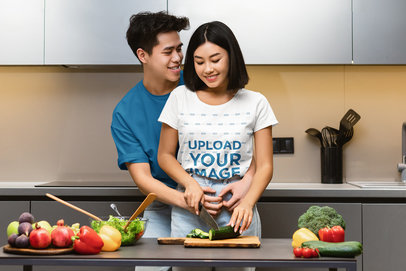 T-Shirt Mockup of a Woman Cooking While Her Boyfriend is Hugging Her