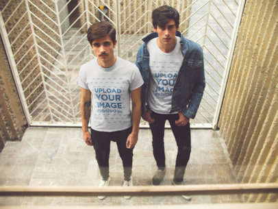 Two Guys Standing Outside a Vintage Elevator Wearing Different T-Shirts Mockup a15733