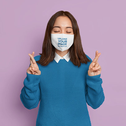 Face Mask Mockup Featuring a Woman Crossing Her Fingers