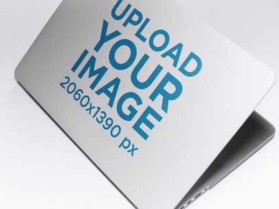 Angled Mockup of a Laptop Cover Lying on a Solid Surface