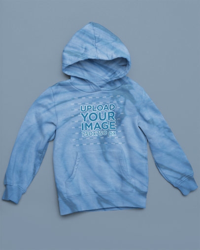 Mockup of a Tie-Dye Hoodie Lying on a Flat-Colored Surface m4122