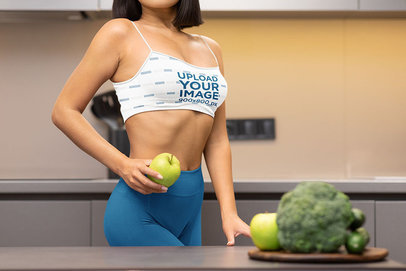 Sports Bra Mockup Featuring a Woman Holding an Apple 