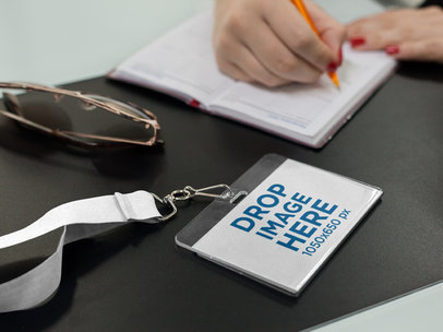 Mockup of a Badge Holder Lying Near a Woman While Writing