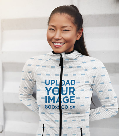 Mockup Featuring a Happy Young Woman Wearing a Sublimated Full-Zip Hoodie 