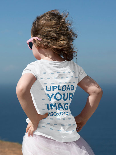 Back-View T-Shirt Mockup Featuring a Little Girl Outdoors