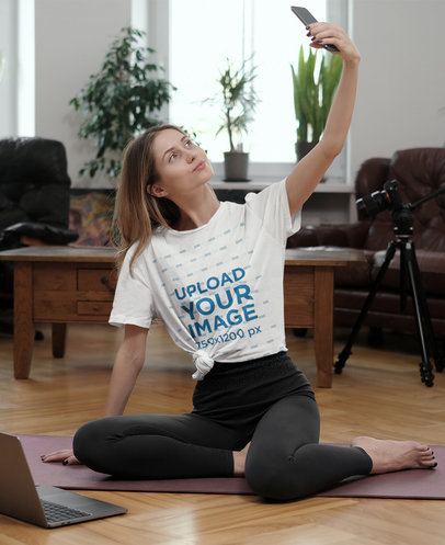 Mockup of a Woman in a Knotted Tee Taking a Selfie at Home