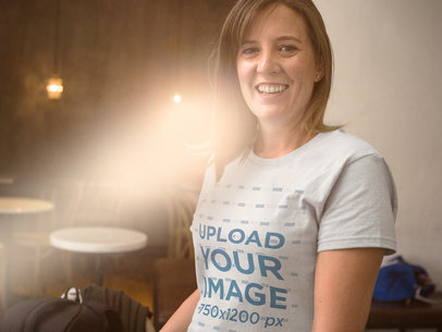 White Woman Wearing a Round Neck Tee Smiling While Against a Ray of Light