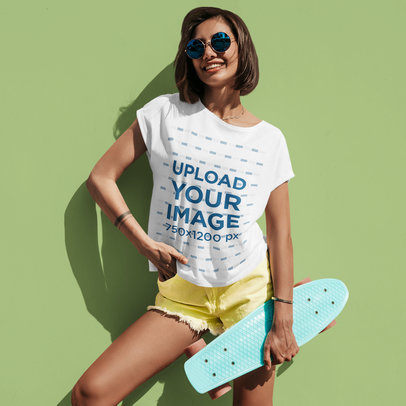 Mockup of a Short-Haired Woman Wearing a Slouchy Tee While Holding a Penny Board