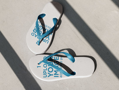 Pair of Flip Flops Lying on the Concrete Floor with Different Designs