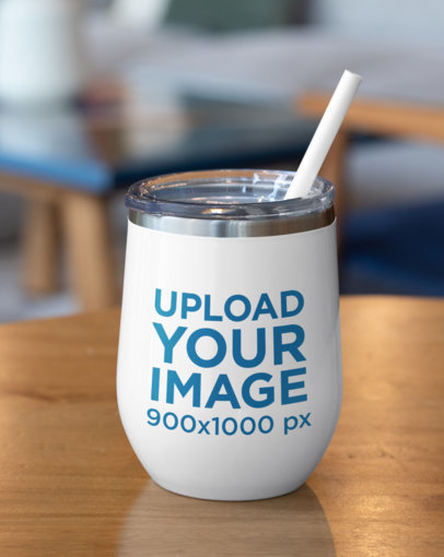 Mockup of a Wine Tumbler with Straw Placed on a Wooden Table