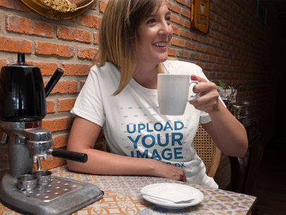 Smiling Middle Aged White Woman Wearing a Tee Mockup While Drinking a Coffee
