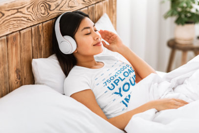 T-Shirt Mockup of a Woman Listening to Music in Bed