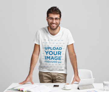 Studio Mockup of a Man With Glasses Wearing a T-Shirt in a Work Setting