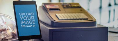 Mockup of an iPad Mini Next to a Cashing Machine