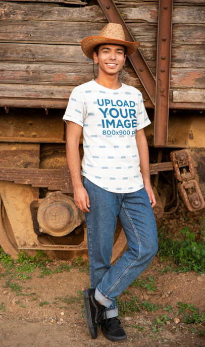 Sublimated T-Shirt Mockup of a Young Man Wearing a Hat in a Rural Scenario