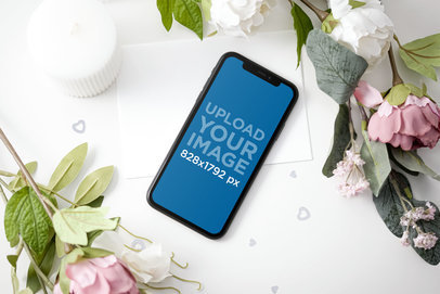 Mockup of an iPhone 11 Placed by Some Roses 5151-el1
