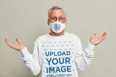 Face Mask and Sweatshirt Mockup of a Confused Man in a Studio