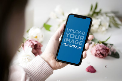 Mockup of a Woman Holding an iPhone 11 by Some Valentine's Day Gifts 5145-el1